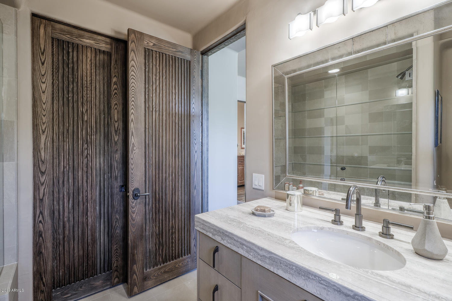 10040 East Happy Valley Road, Unit 442 Scottsdale, AZ 85255 - Photo 36 of 78 a bathroom with a granite countertop sink a mirror and a shower