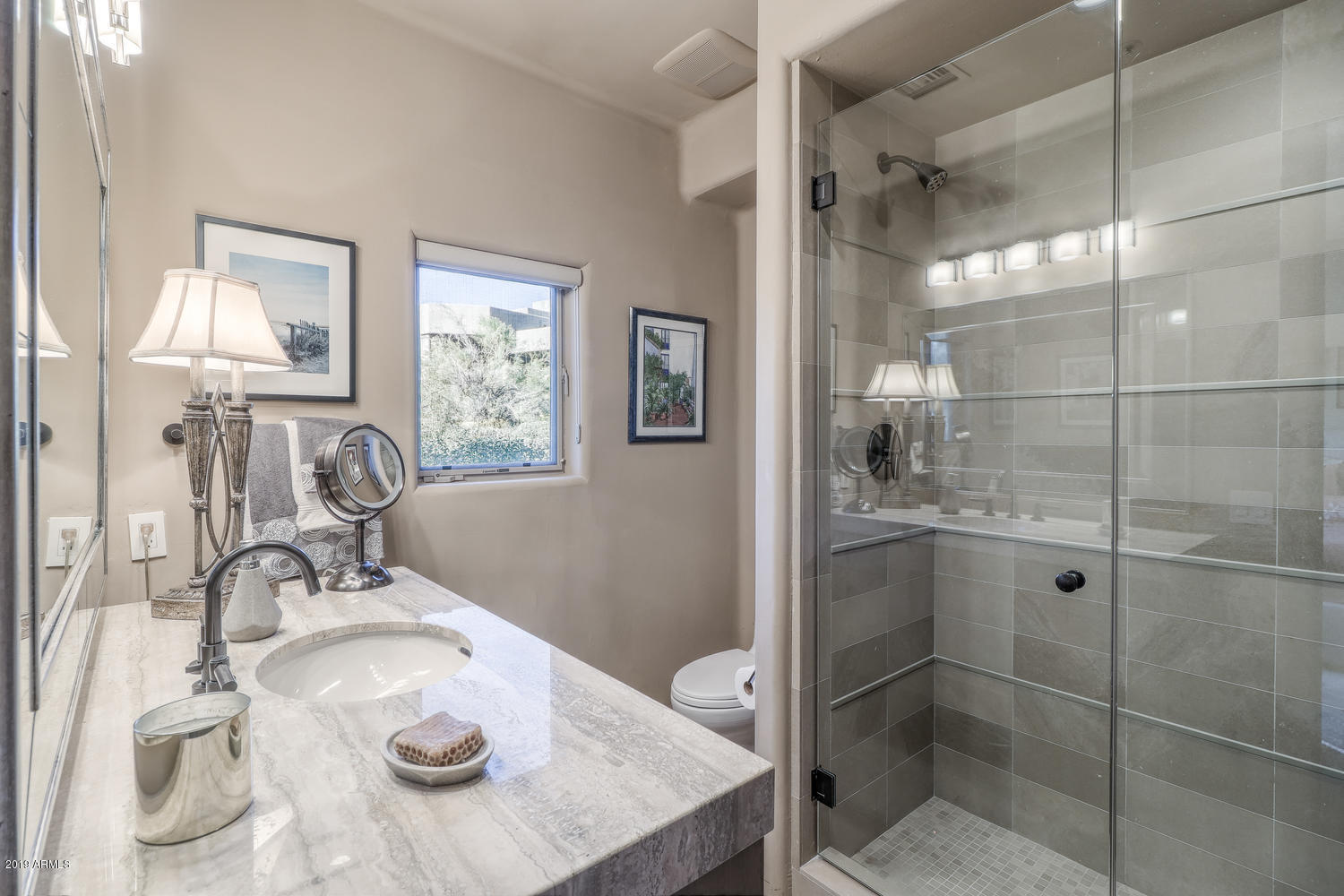 10040 East Happy Valley Road, Unit 442 Scottsdale, AZ 85255 - Photo 37 of 78 a bathroom with a granite countertop sink a mirror and shower