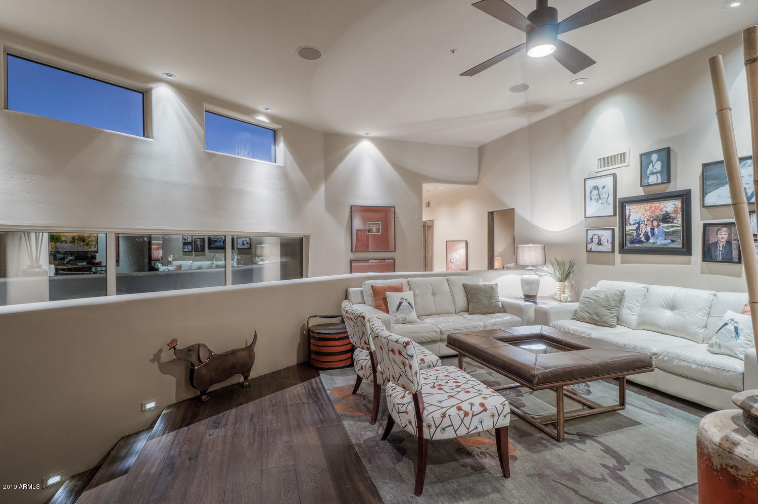 10040 East Happy Valley Road, Unit 442 Scottsdale, AZ 85255 - Photo 39 of 78 a living room with furniture and a wooden floor