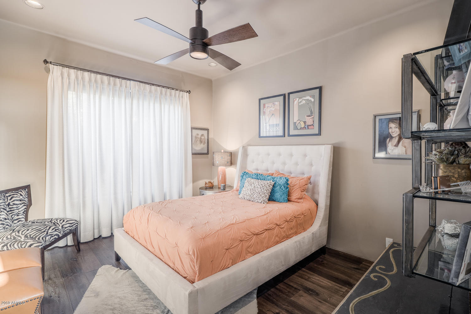 10040 East Happy Valley Road, Unit 442 Scottsdale, AZ 85255 - Photo 45 of 78 a bedroom with a large bed and a chandelier
