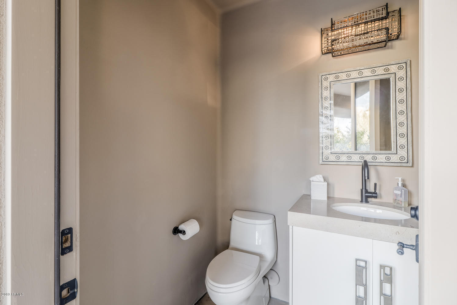 10040 East Happy Valley Road, Unit 442 Scottsdale, AZ 85255 - Photo 50 of 78 a bathroom with a toilet a sink and mirror