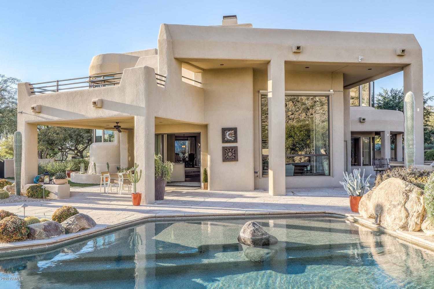 10040 East Happy Valley Road, Unit 442 Scottsdale, AZ 85255 - Photo 55 of 78 a view of a house with a swimming pool and a porch with furniture