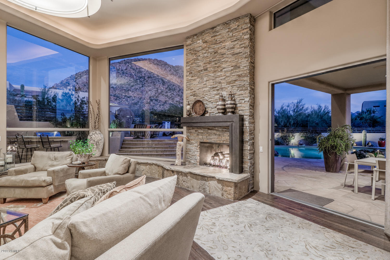 10040 East Happy Valley Road, Unit 442 Scottsdale, AZ 85255 - Photo 10 of 78 a living room with furniture a fireplace and a floor to ceiling window
