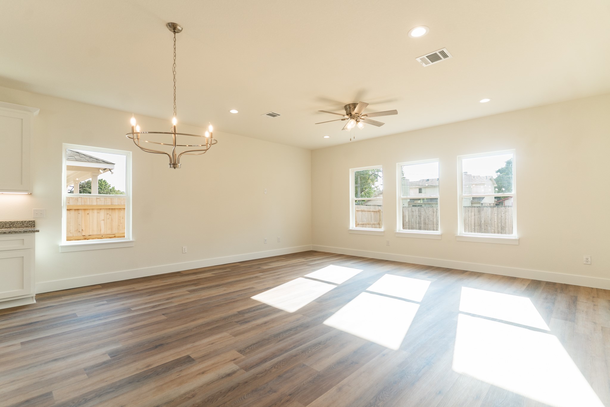 309 String Prairie Way Smithville, TX 78957 - Photo 13 of 30 a view of an empty room with a window and wooden floor
