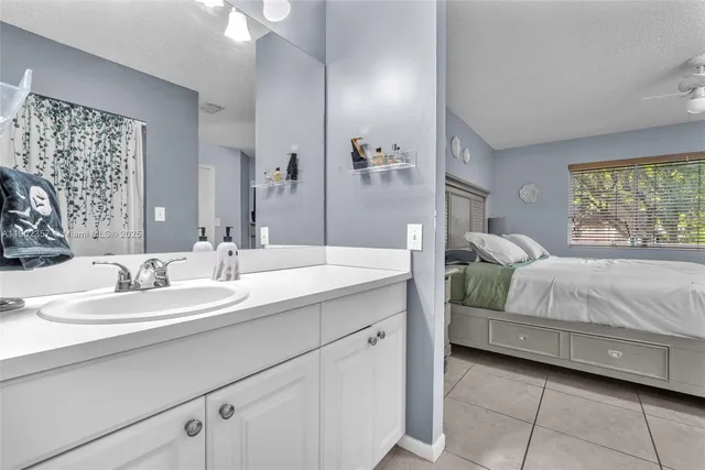 a en suite bathroom with a double vanity sink and a mirror