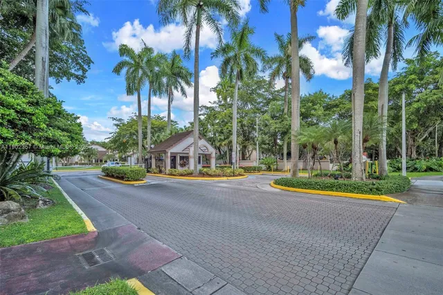 a view of a house with palm trees