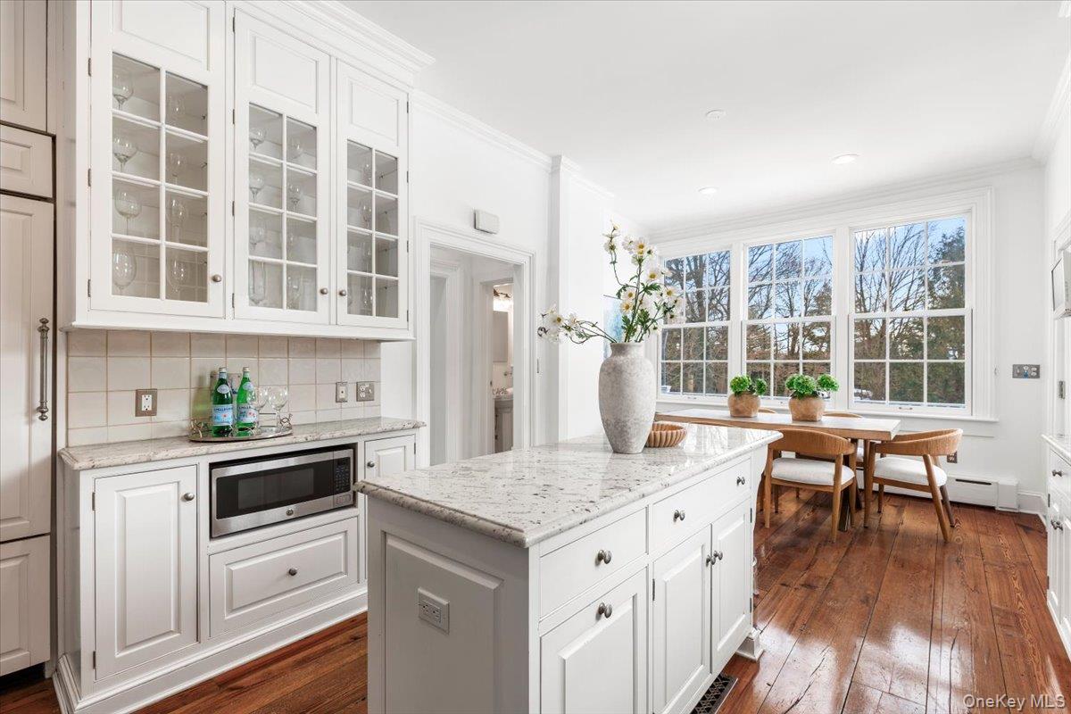 77 Pleasant Ridge Road Harrison, NY 10528 - Photo 13 of 35 a kitchen with granite countertop kitchen island wooden floors and center island