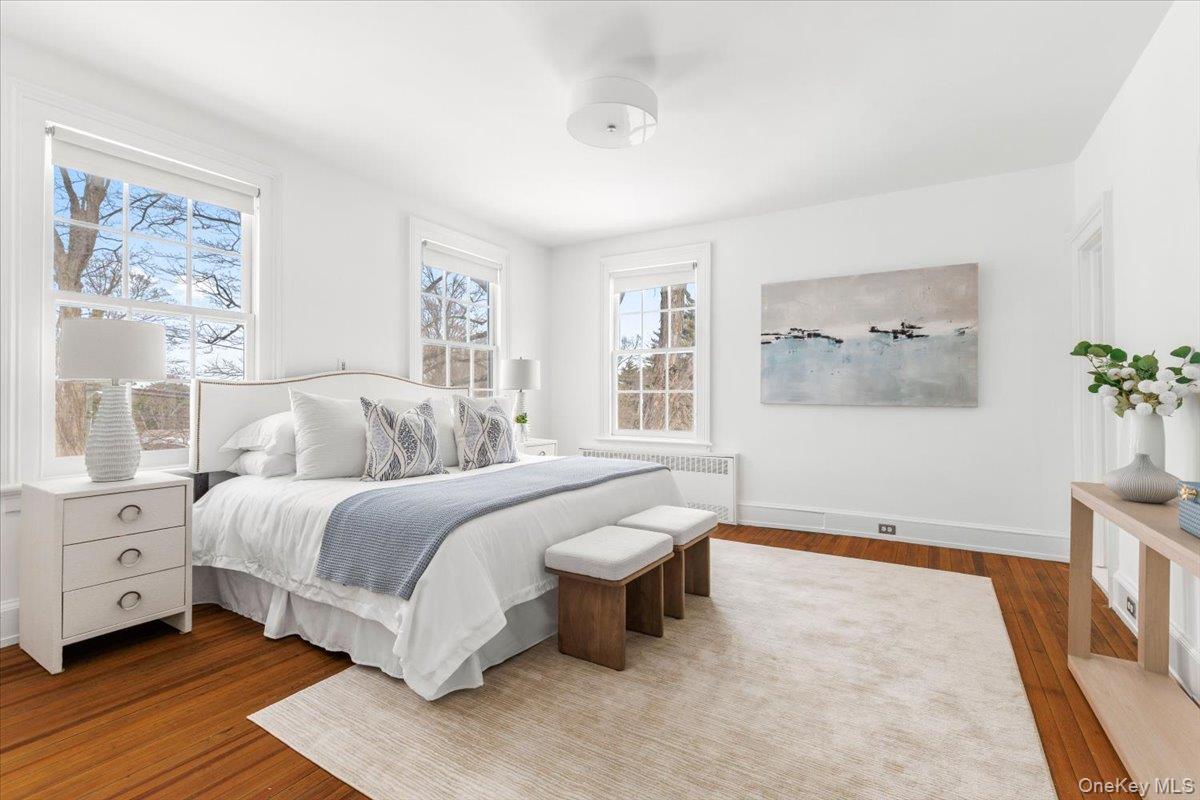 77 Pleasant Ridge Road Harrison, NY 10528 - Photo 17 of 35 a spacious bedroom with a bed and a window