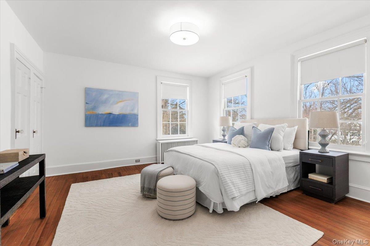 77 Pleasant Ridge Road Harrison, NY 10528 - Photo 19 of 35 a bedroom with a bed and wooden floor