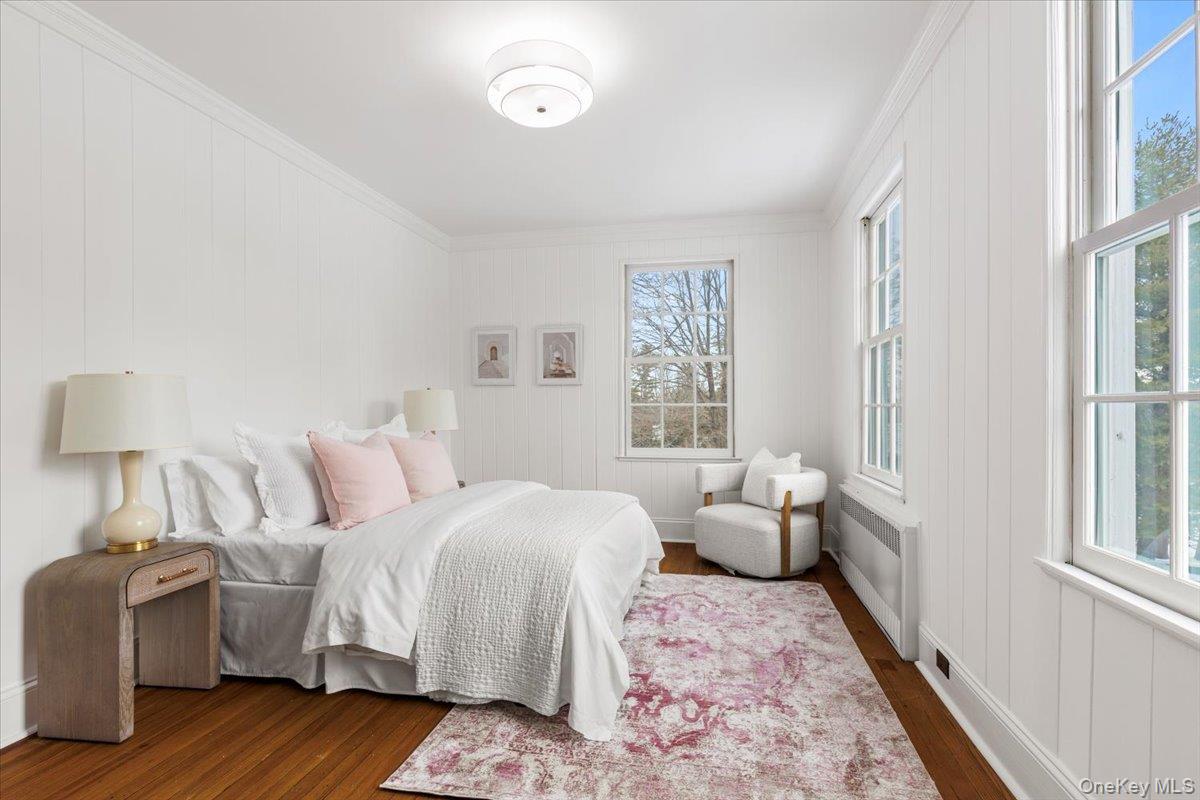 77 Pleasant Ridge Road Harrison, NY 10528 - Photo 21 of 35 a spacious bedroom with a bed and wooden floor
