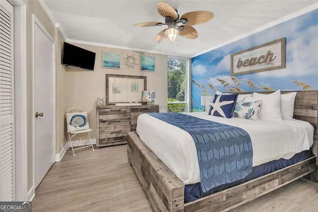 a spacious bedroom with a bed and a chandelier