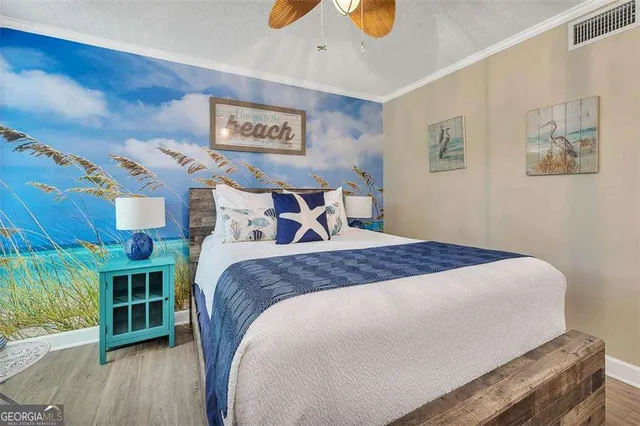 a bedroom with a bed and a wooden floor