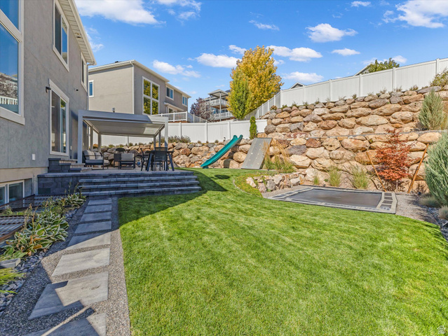 882 Spring Dew Lane Lehi, UT 84048 - Photo 24 of 46 Fenced backyard featuring a playground, a patio, and an outdoor living space