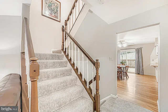 a view of a hallway with wooden floor and staircase