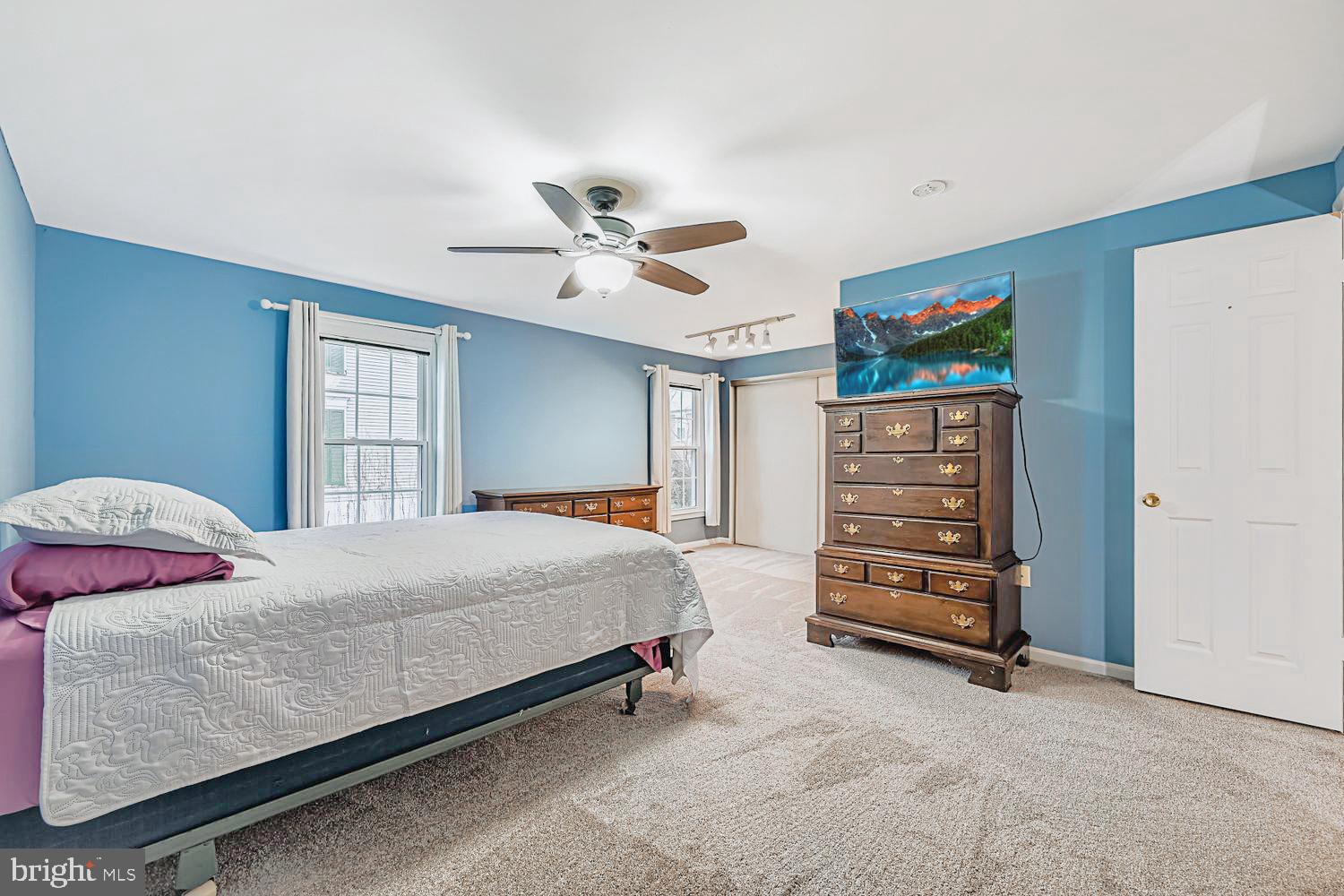 13229 Country Ridge Drive Germantown, MD 20874 - Photo 14 of 24 a bedroom with a bed and a chandelier