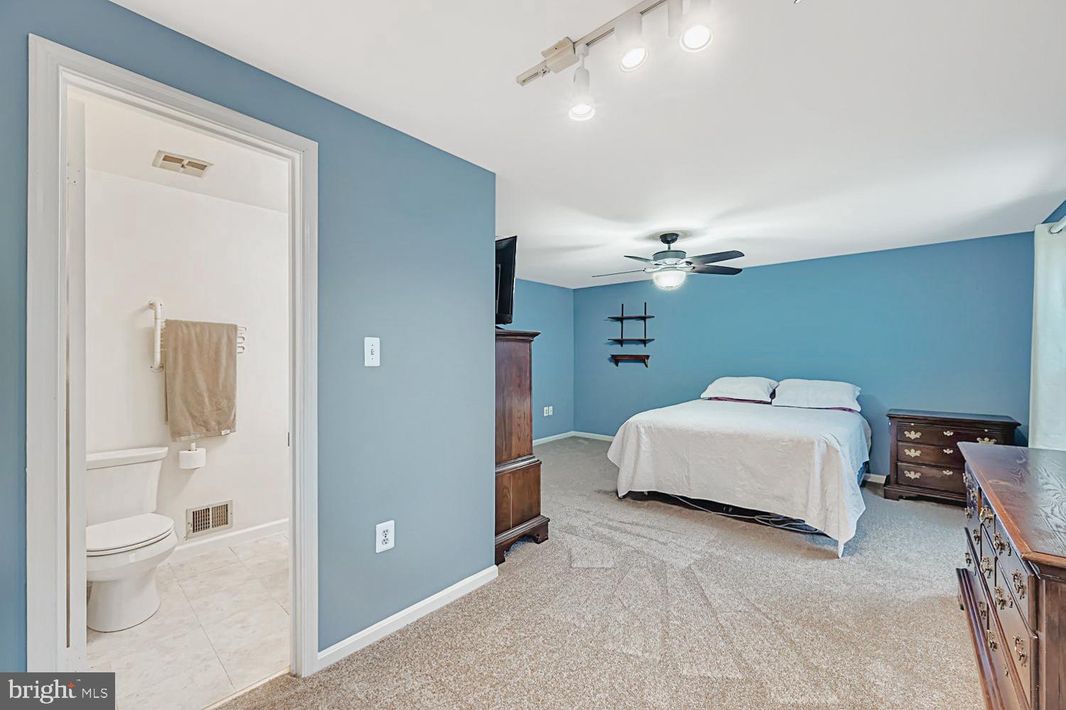 13229 Country Ridge Drive Germantown, MD 20874 - Photo 15 of 24 a bedroom with a bed and a chandelier