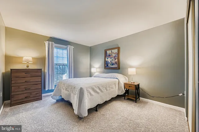 a bedroom with a bed and a mirror