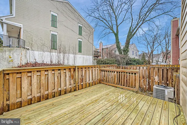 a balcony with wooden floor and fence