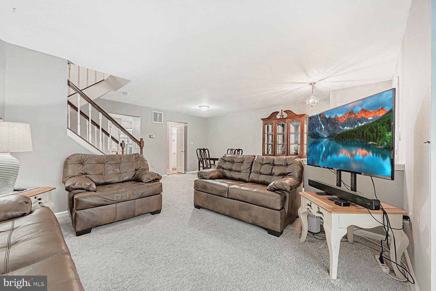 13229 Country Ridge Drive Germantown, MD 20874 - Photo 4 of 24 a living room with furniture and a flat screen tv