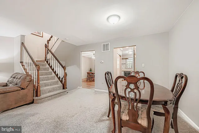 a view of a dining room with furniture and stairs