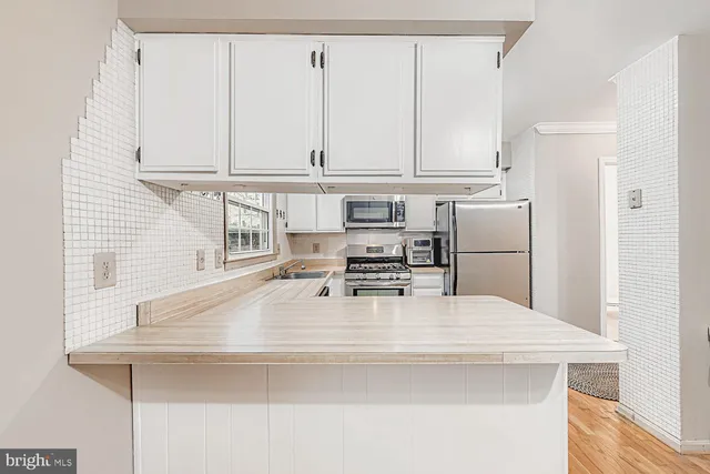 a kitchen with appliances cabinets and a sink
