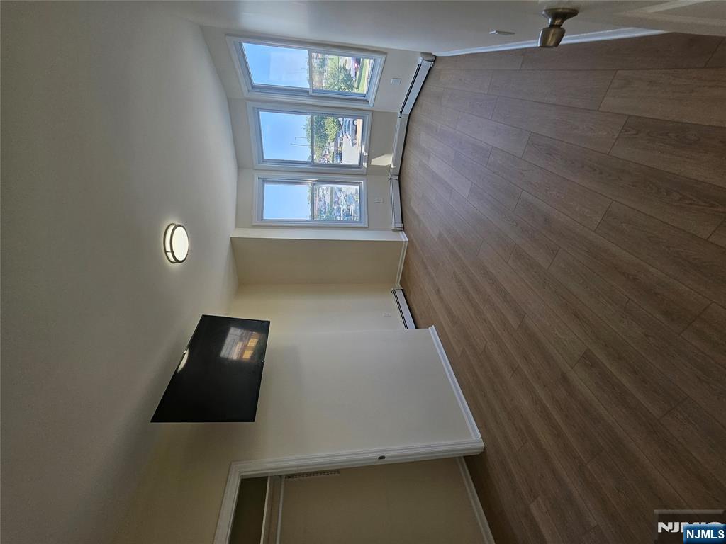 372 Bergen Street Newark, NJ 07103 - Photo 11 of 29 an empty room with wooden floor and windows