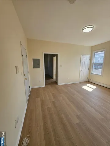 a view of a livingroom with wooden floor and closet