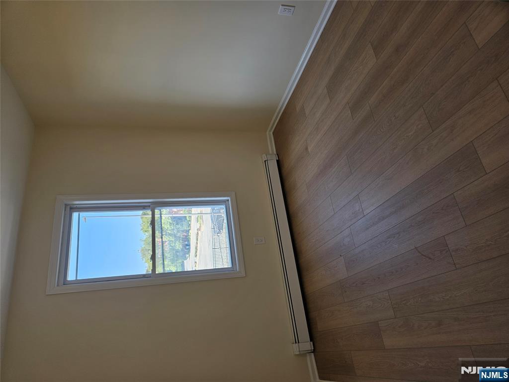 372 Bergen Street Newark, NJ 07103 - Photo 15 of 29 an empty room with wooden floor and windows