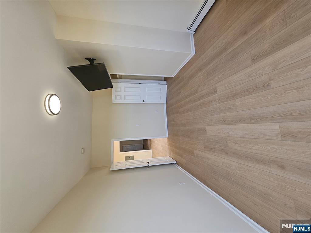 372 Bergen Street Newark, NJ 07103 - Photo 2 of 29 a view of empty room with wooden floor and fan