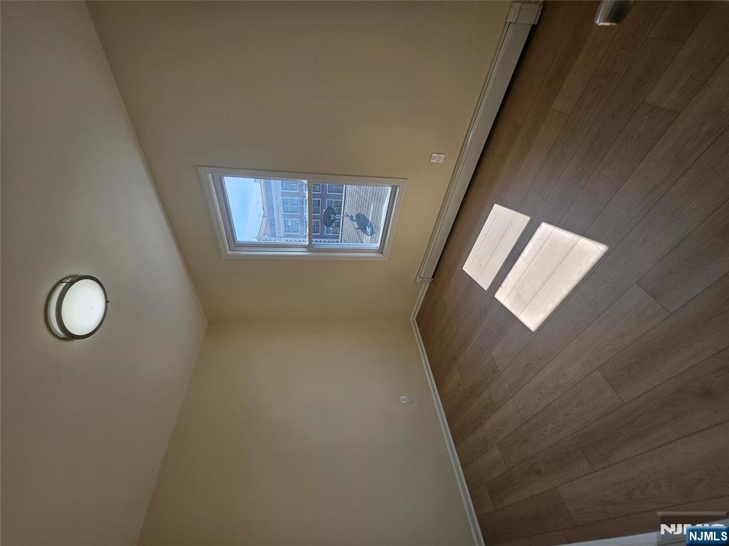 372 Bergen Street Newark, NJ 07103 - Photo 26 of 29 an empty room with wooden floor and windows