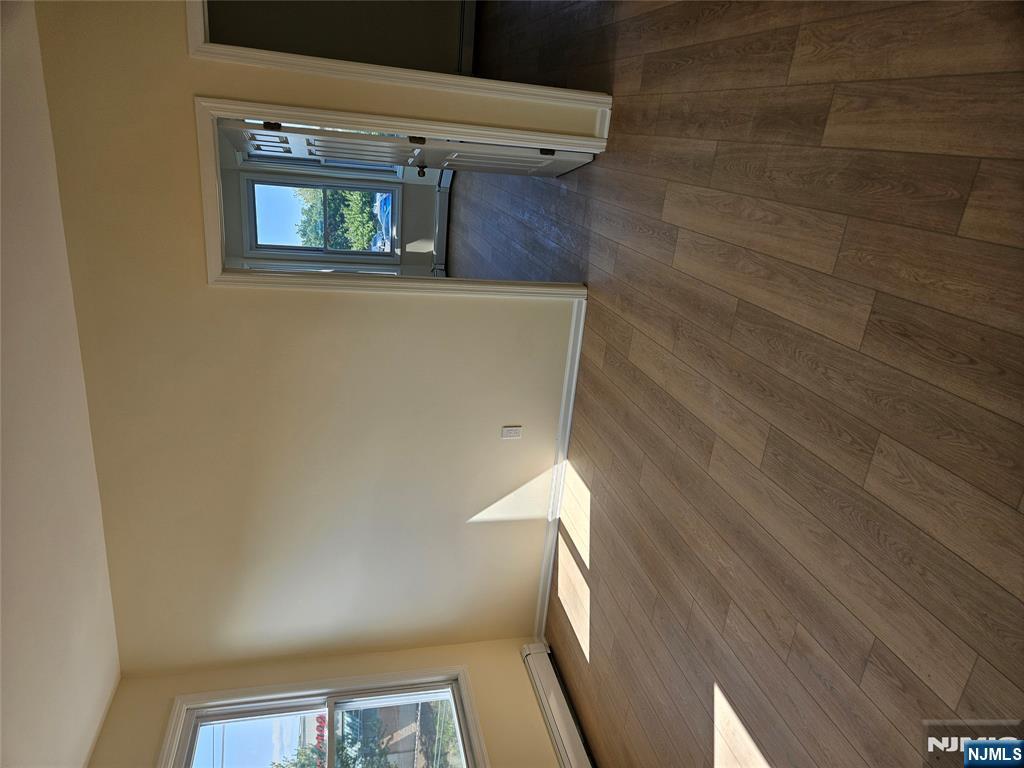 372 Bergen Street Newark, NJ 07103 - Photo 7 of 29 wooden floor in an empty room with a window