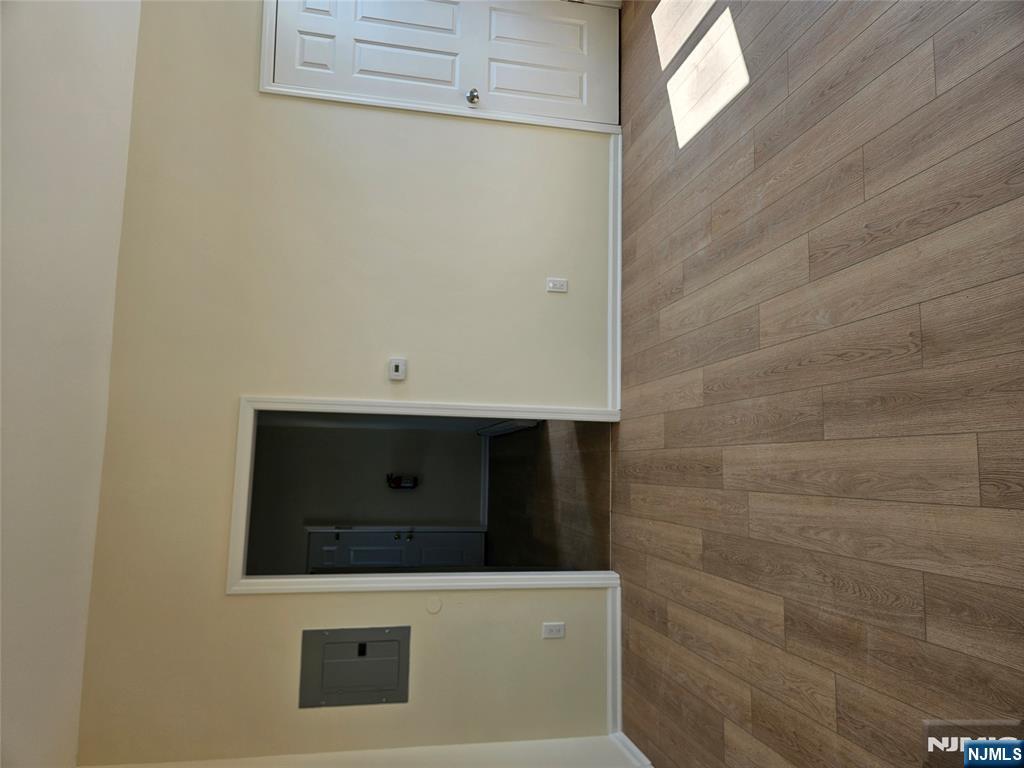 372 Bergen Street Newark, NJ 07103 - Photo 8 of 29 a view of an empty room with wooden floor and cabinet