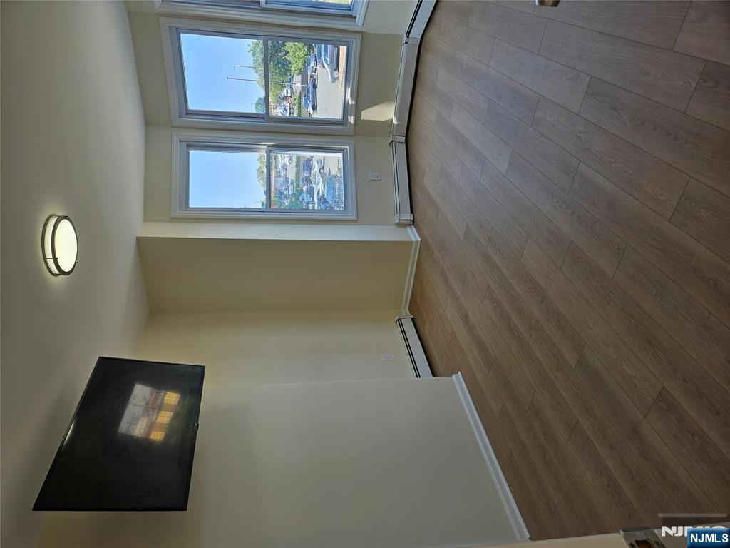 372 Bergen Street Newark, NJ 07103 - Photo 10 of 29 an empty room with wooden floor and windows