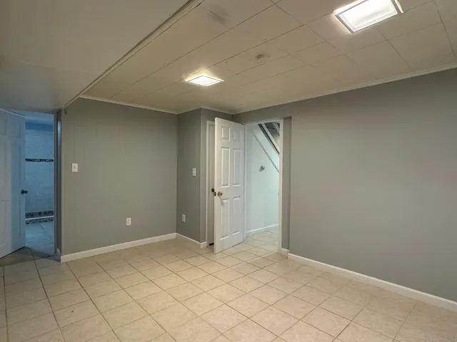 an empty room with white walls and tiles