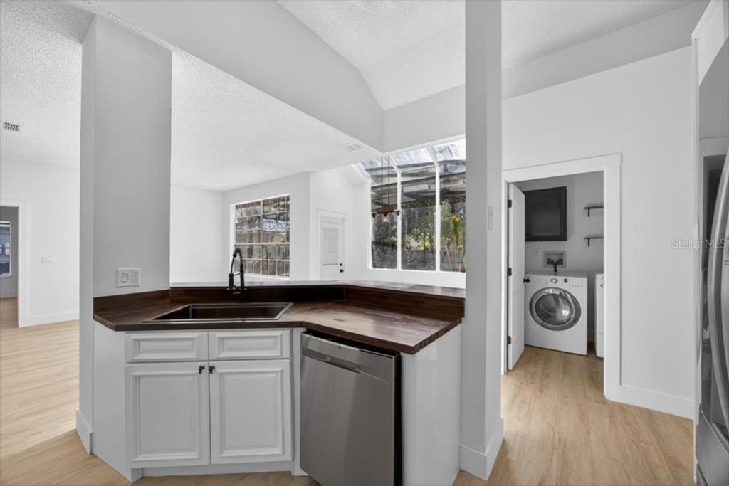 8618 Valley Ridge Court Orlando, FL 32818 - Photo 11 of 24 a view of a sink and dishwasher with wooden floor