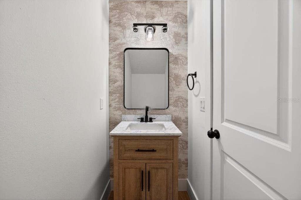 8618 Valley Ridge Court Orlando, FL 32818 - Photo 12 of 24 a sink with a mirror