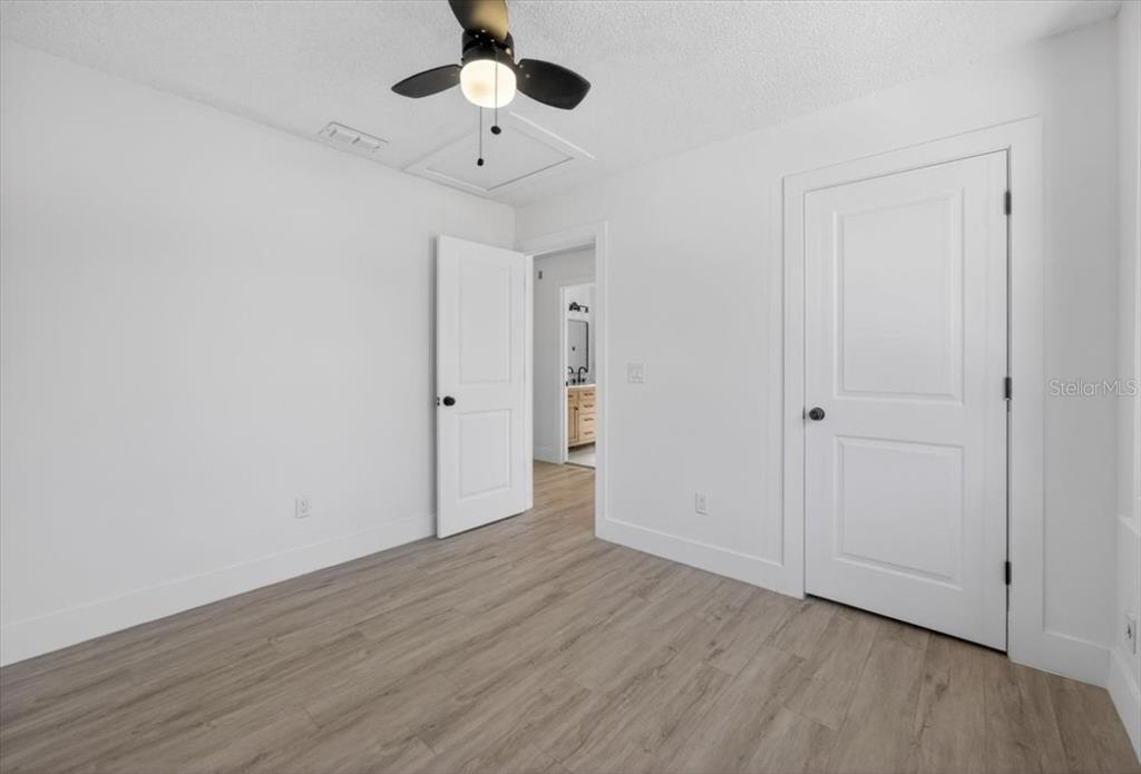 8618 Valley Ridge Court Orlando, FL 32818 - Photo 13 of 24 a view of an empty room with wooden floor