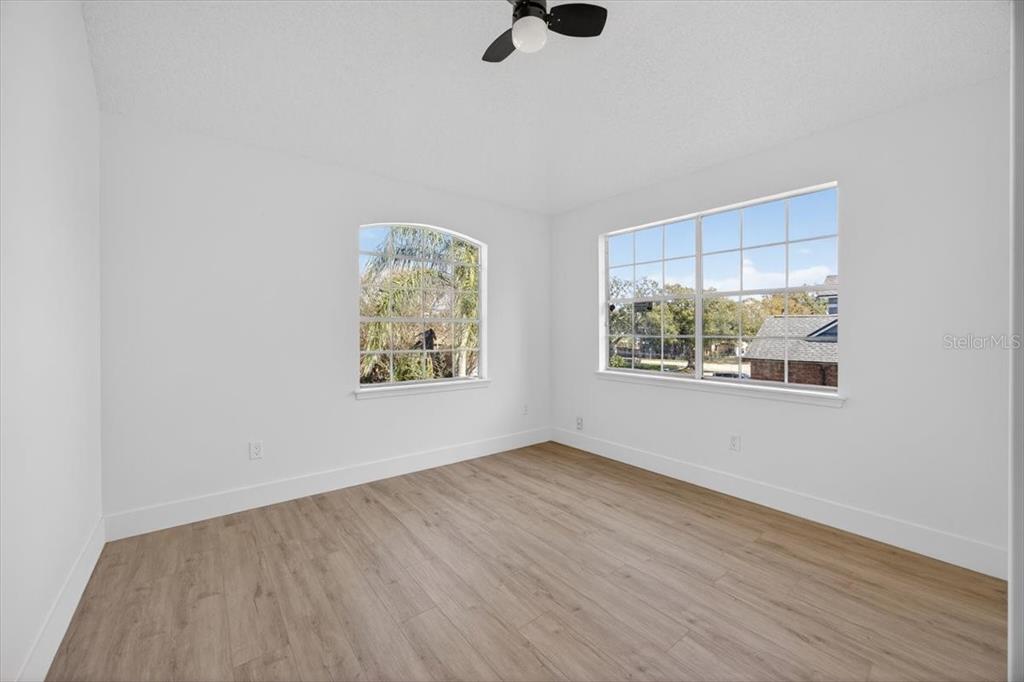 8618 Valley Ridge Court Orlando, FL 32818 - Photo 14 of 24 an empty room with wooden floor and window