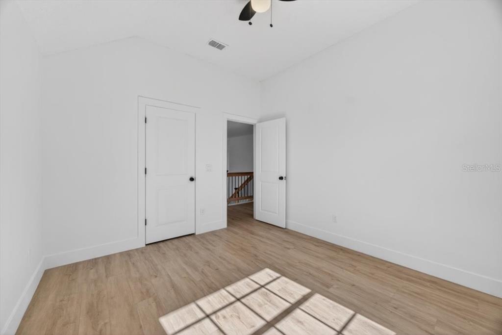 8618 Valley Ridge Court Orlando, FL 32818 - Photo 15 of 24 a view of an empty room with wooden floor