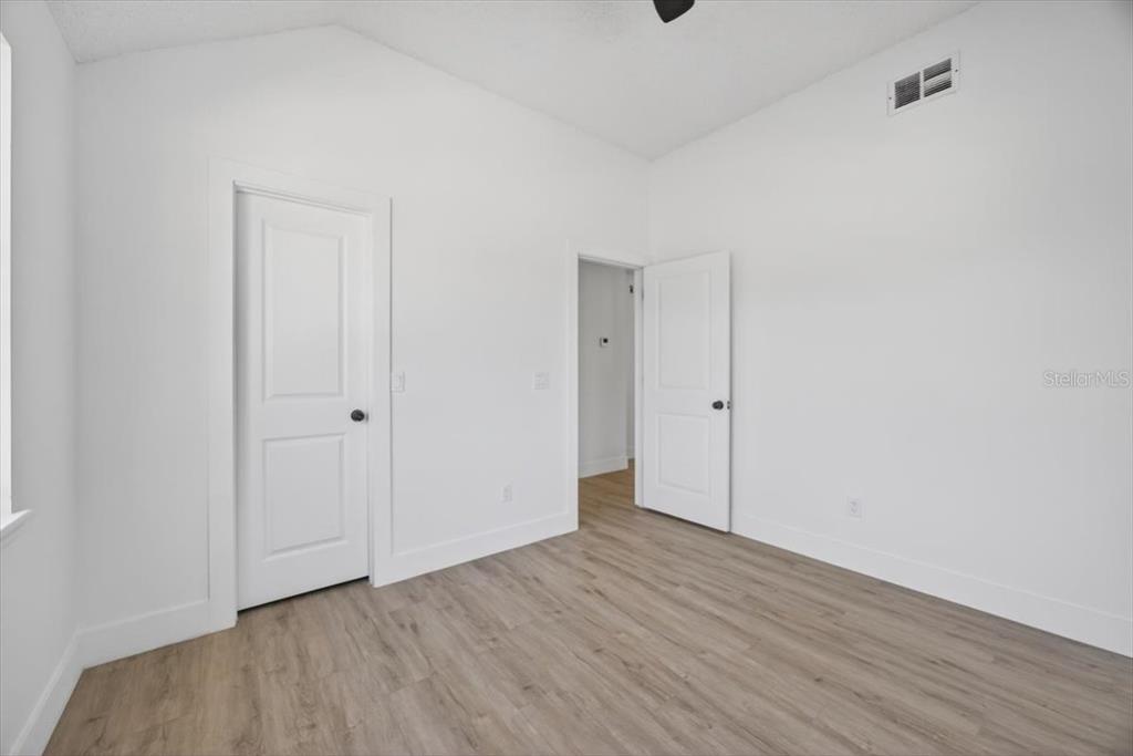 8618 Valley Ridge Court Orlando, FL 32818 - Photo 16 of 24 a view of an empty room with wooden floor