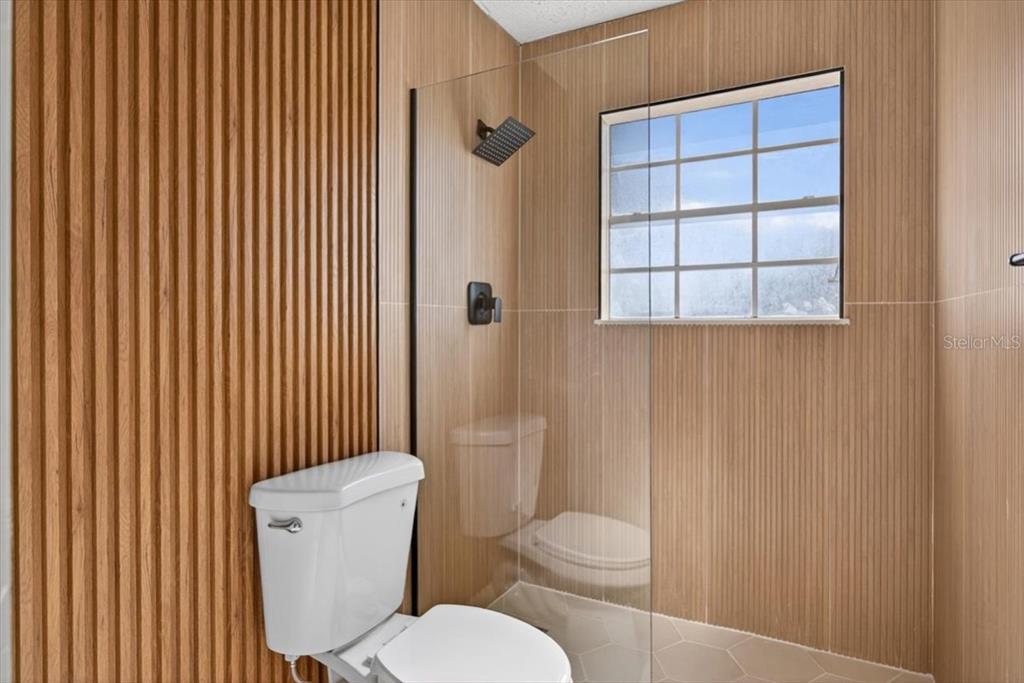 8618 Valley Ridge Court Orlando, FL 32818 - Photo 18 of 24 a white toilet sitting next to a bathroom sink