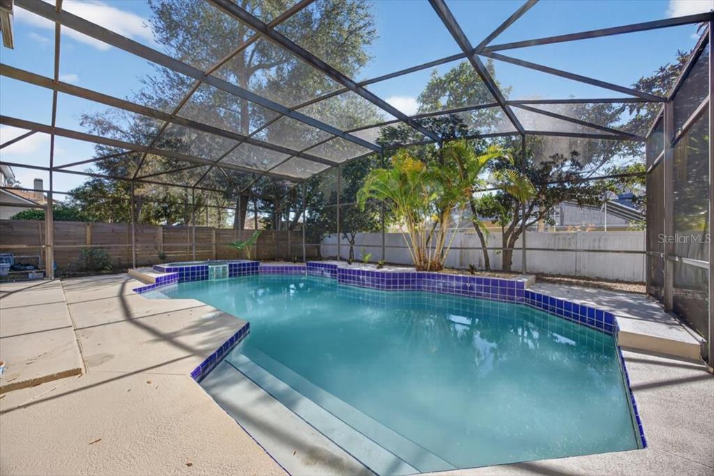 8618 Valley Ridge Court Orlando, FL 32818 - Photo 21 of 24 a view of a swimming pool with a patio