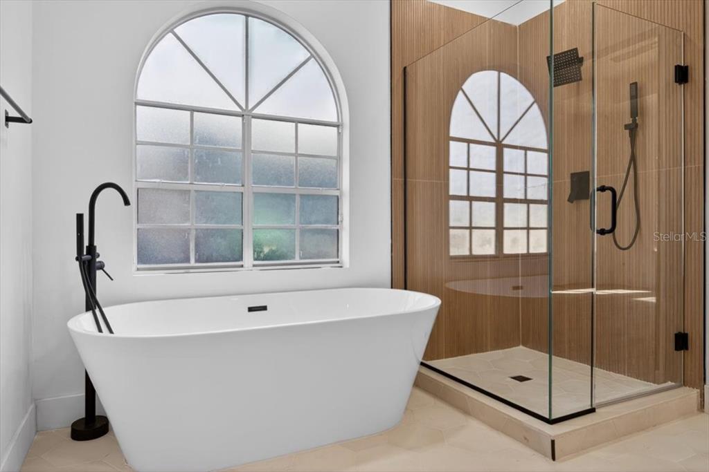 8618 Valley Ridge Court Orlando, FL 32818 - Photo 8 of 24 a bathroom with a bathtub and a shower