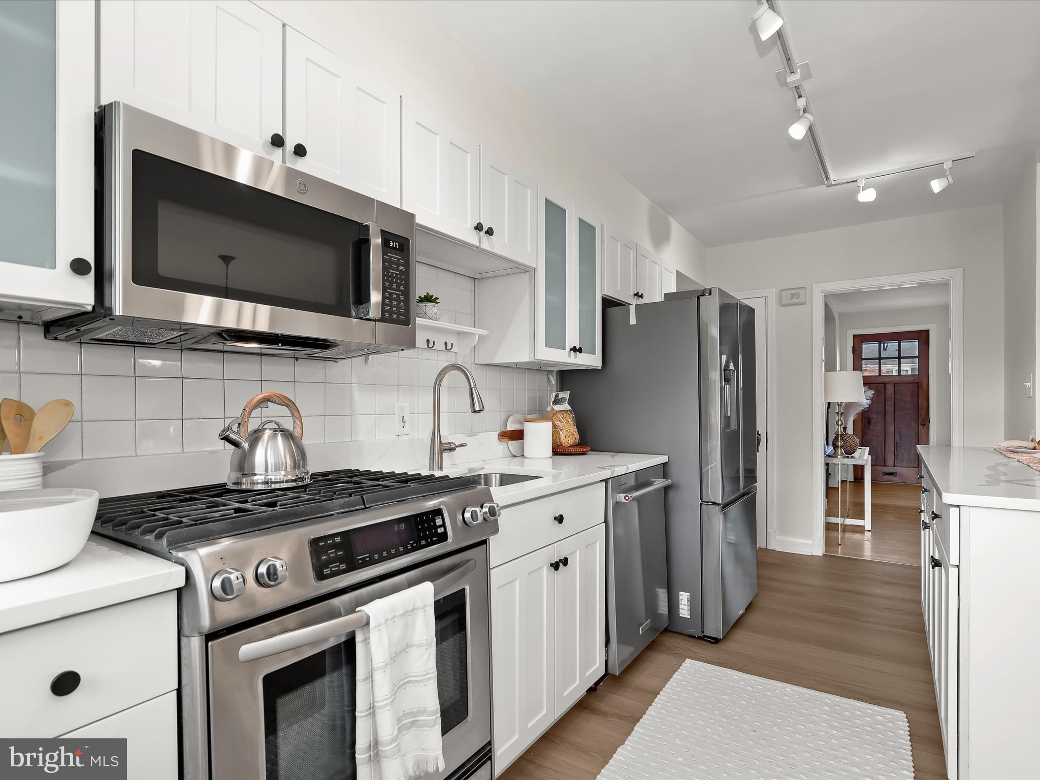 317 Overbrook Road Baltimore, MD 21212 - Photo 20 of 52 a kitchen with stainless steel appliances granite countertop a stove a refrigerator and a sink