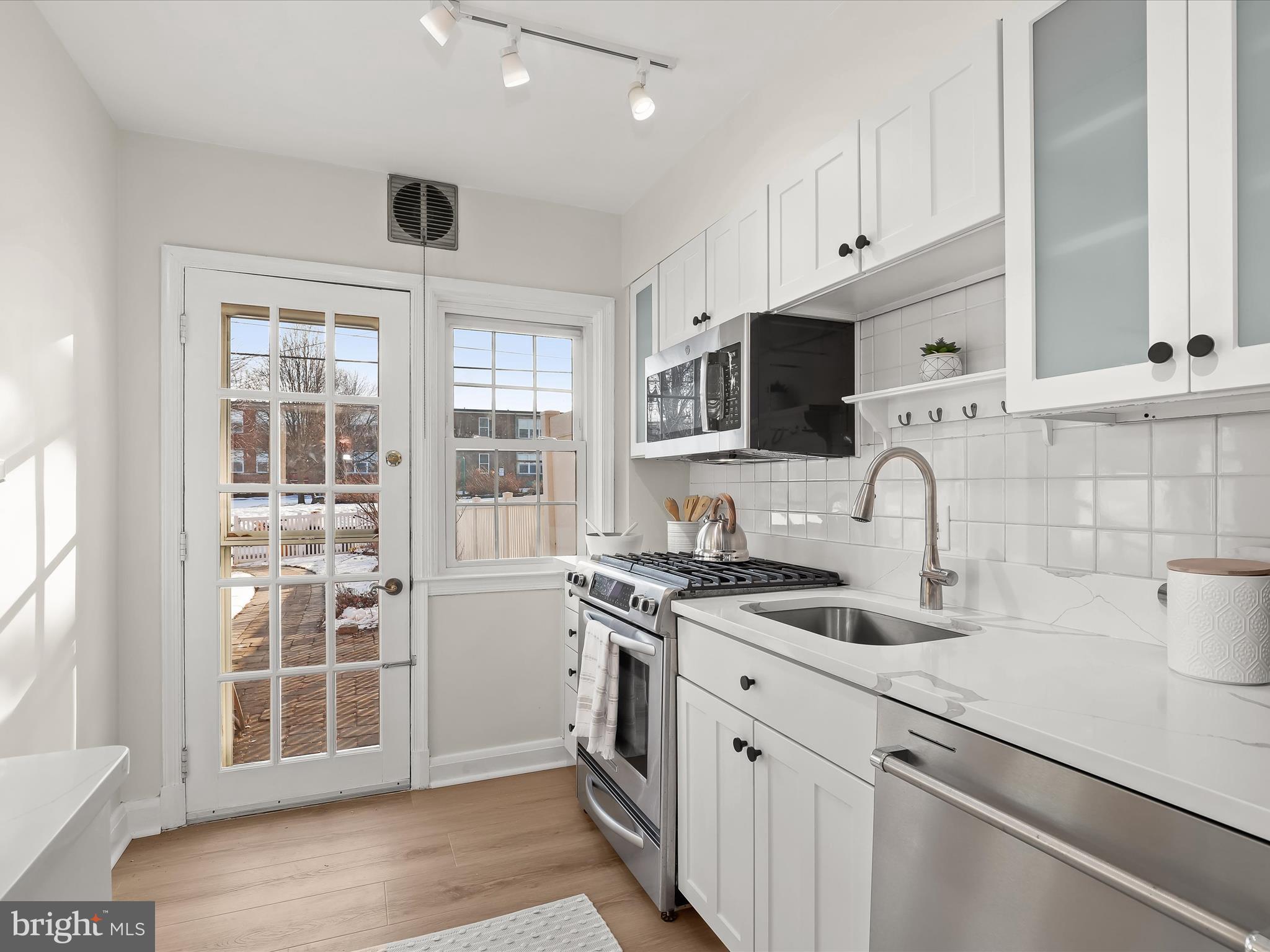 317 Overbrook Road Baltimore, MD 21212 - Photo 23 of 52 a kitchen with stainless steel appliances granite countertop a sink and a stove top oven