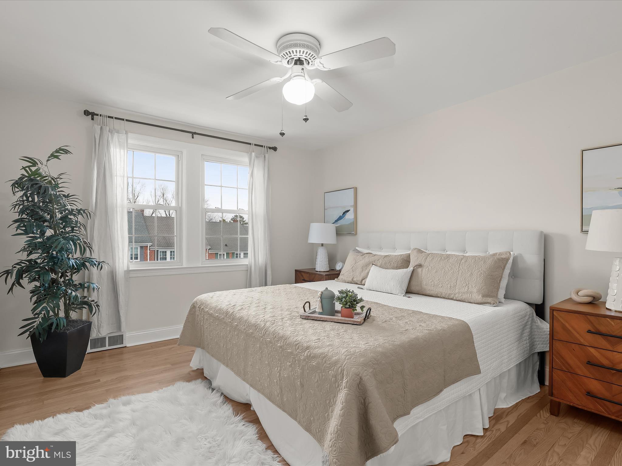 317 Overbrook Road Baltimore, MD 21212 - Photo 27 of 52 a bedroom with a large bed and a potted plant