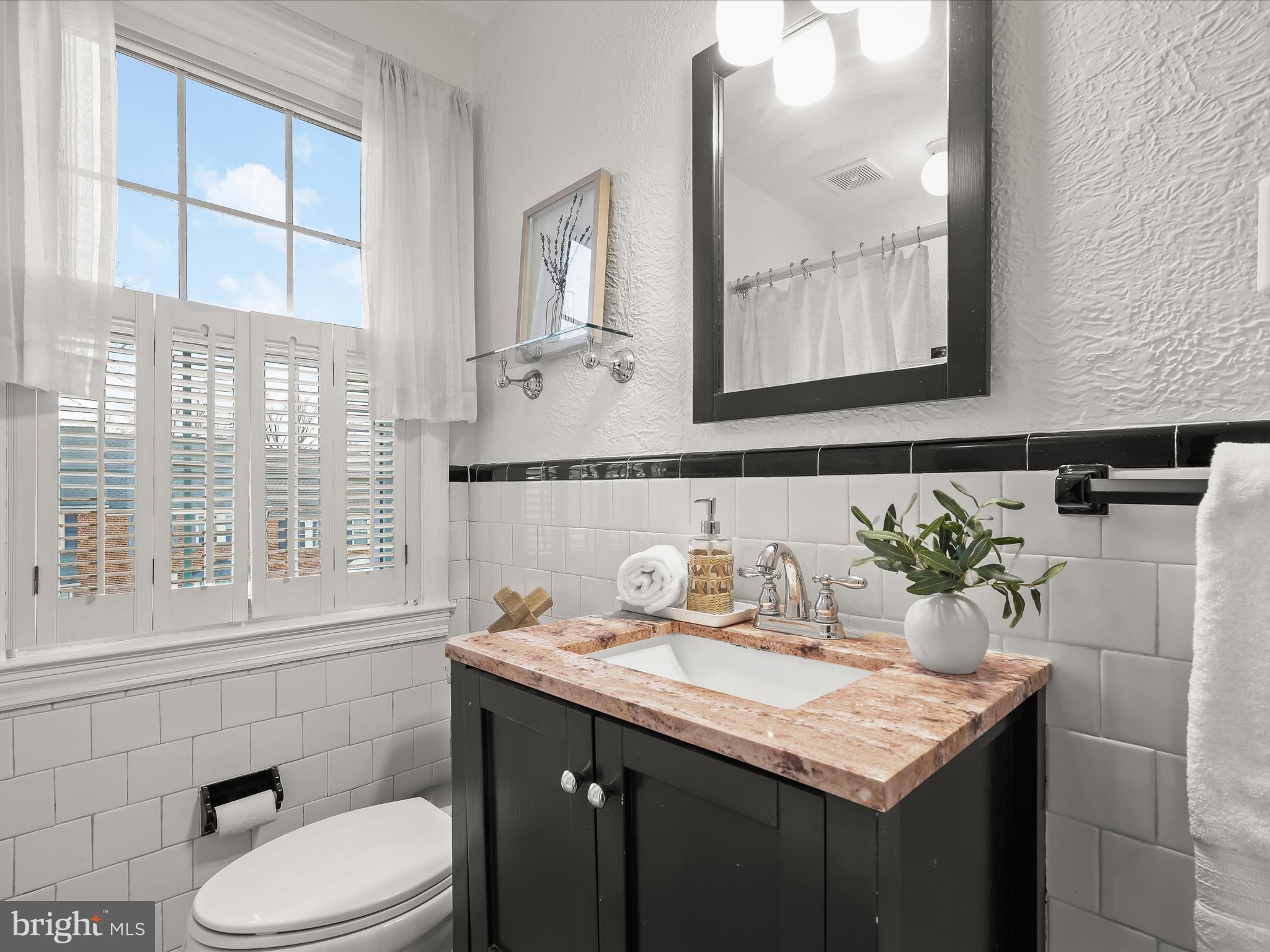 317 Overbrook Road Baltimore, MD 21212 - Photo 32 of 52 a bathroom with a granite countertop sink and a mirror