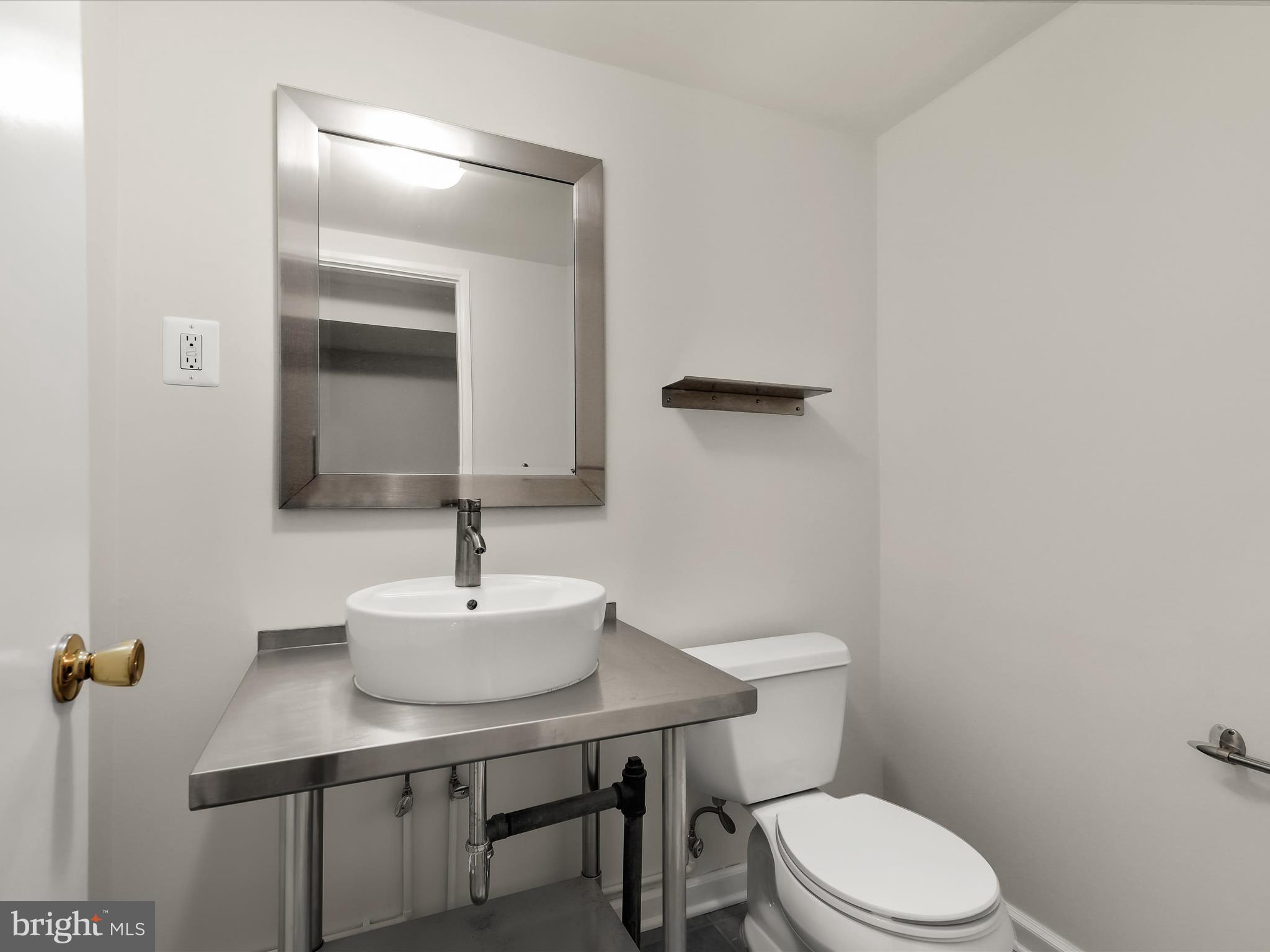 317 Overbrook Road Baltimore, MD 21212 - Photo 38 of 52 a bathroom with a sink a toilet and mirror