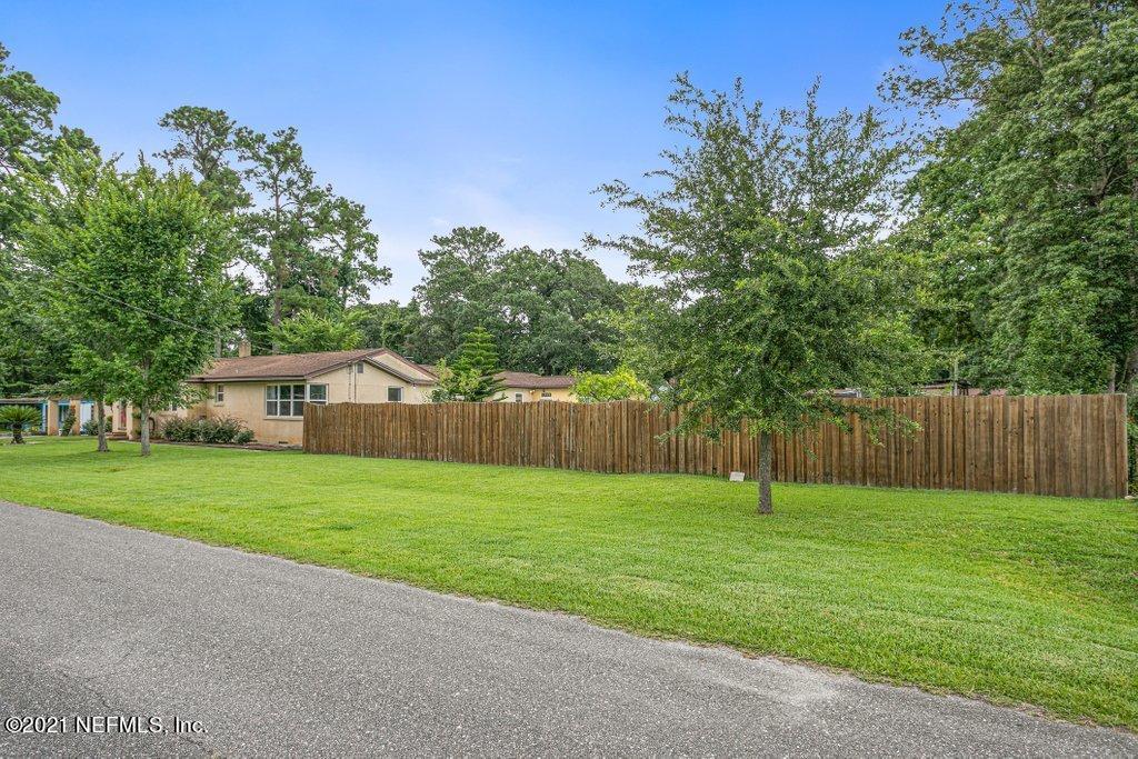 4011 Springwood Road Jacksonville, FL 32207 - Photo 43 of 43 a front view of a house with a yard and garage