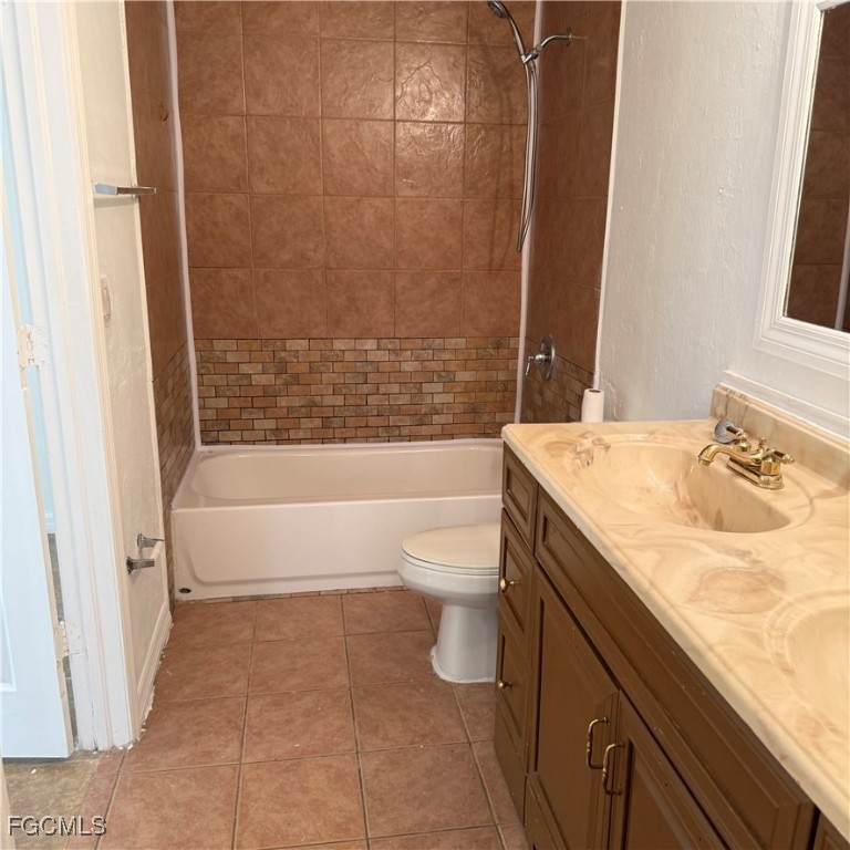 2172 Simon Court Fort Myers, FL 33916 - Photo 14 of 15 a bathroom with a granite countertop bathtub sink vanity mirror and toilet